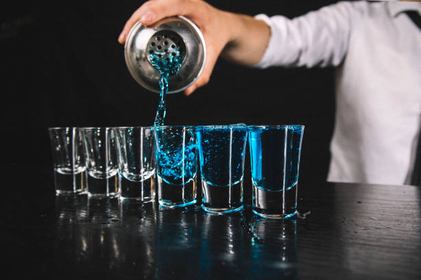 istock Close up of barman making blue shots 1187613821