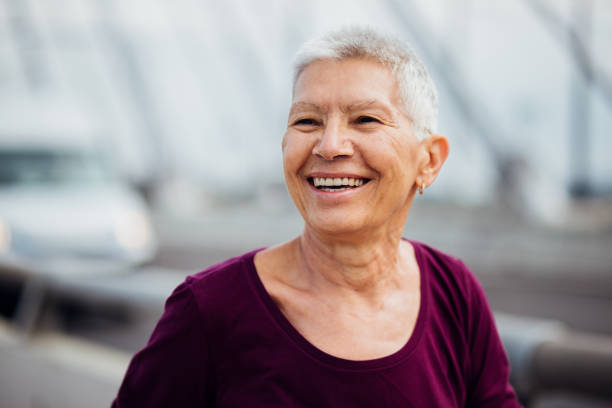 istock Cheerful older woman laughing 1187614006