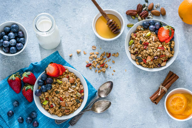 istock Healthy eating: two granola bowls with fruits for breakfast. Top view 1187614196