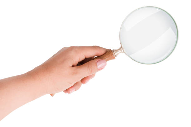 Women hand holding magnifying glass isolated on white background