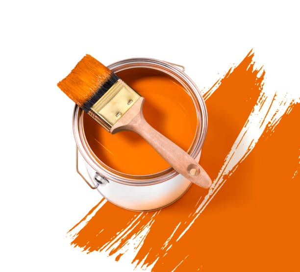 istock Orange paint tin can with brush on top on a white background with orange strokes 1187615801