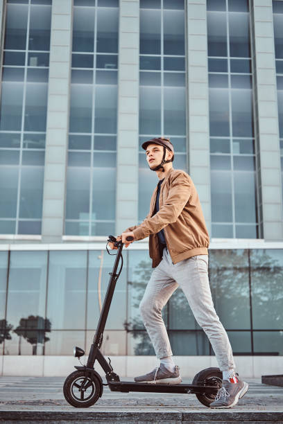 istock Young man is driving his hew electro scooter 1187619448