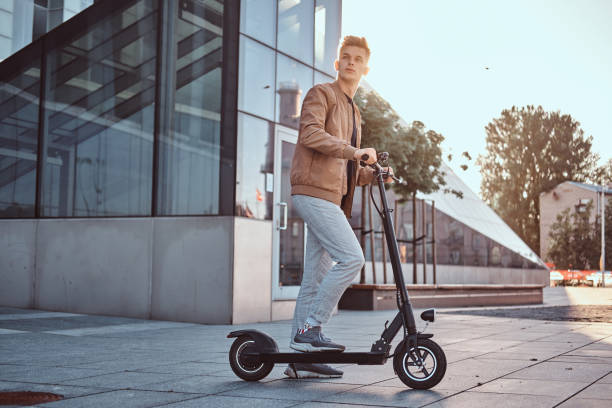 istock Young man is driving his hew electro scooter 1187619494