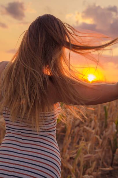 istock woman in the fields on sunset. Travel concept 1187619717