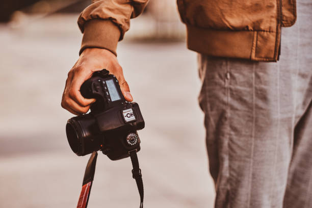 istock Man is carrying his digital photo camera 1187619827