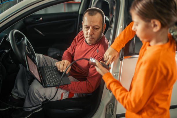 istock Curious boy in car service shop 1187624105