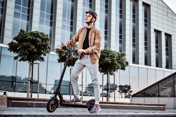 istock Young man is driving his hew electro scooter 1187625887