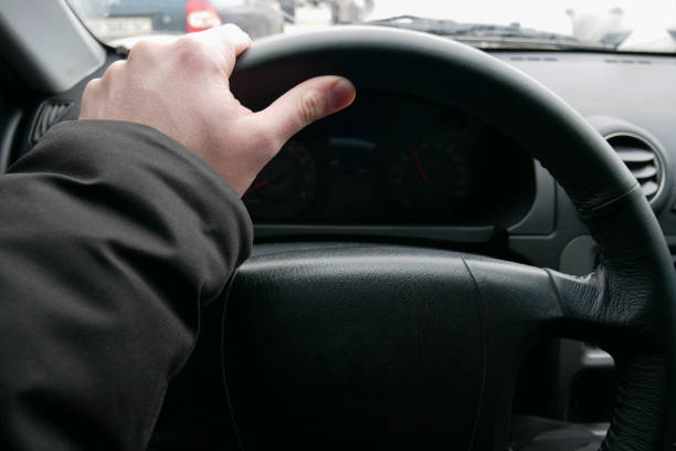 istock The driver's hand on the steering wheel driving 1187625972