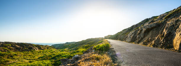 istock Empty long road on a sunny summer day at bright sunset 1187626326