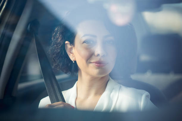 istock Business woman using seatbelt. 1187626346