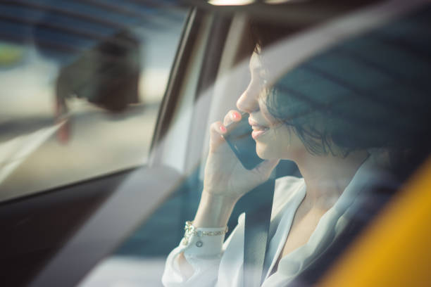 istock Businesswoman using a smartphone in a car 1187626519