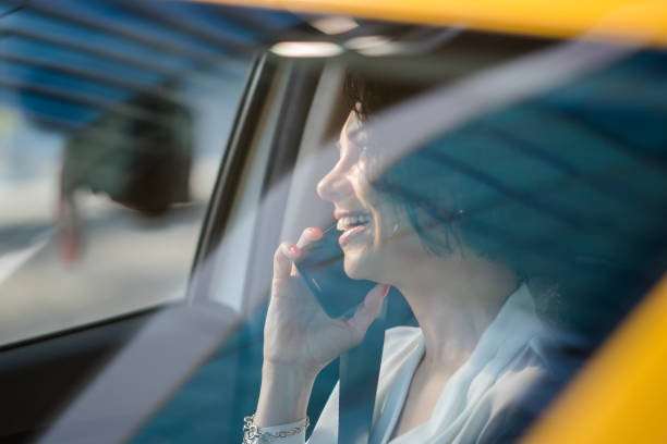 istock Businesswoman using a smartphone in a car 1187626593