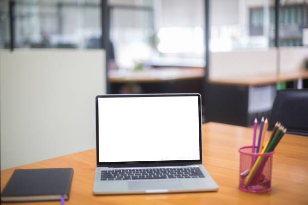 istock Computer laptop with white blank screen isolated  on work table in office. 1187627380