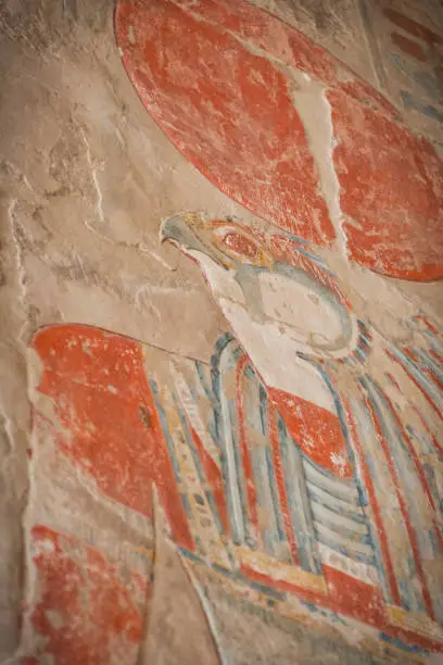 Ra was portrayed as a falcon and shared characteristics with the sky god Horus. At times the two deities were merged as Ra-Horakhty, "Ra, who is Horus of the Two Horizons"