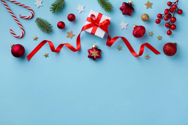 istock Gift or present box and holiday decorations on blue background top view. Christmas or New year greeting card. Flat lay. 1187629249