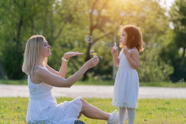 istock Mother and daughter Sharing good times with Bubble Wand 1187630822