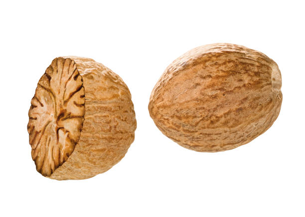 Nutmeg Whole and half nutmeg nuts nutmeg stock pictures, royalty-free photos & images
