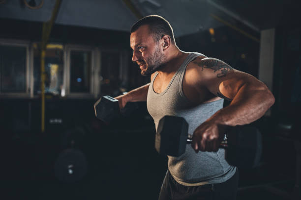 istock Body builder training in gym with dumbbells 1187634965