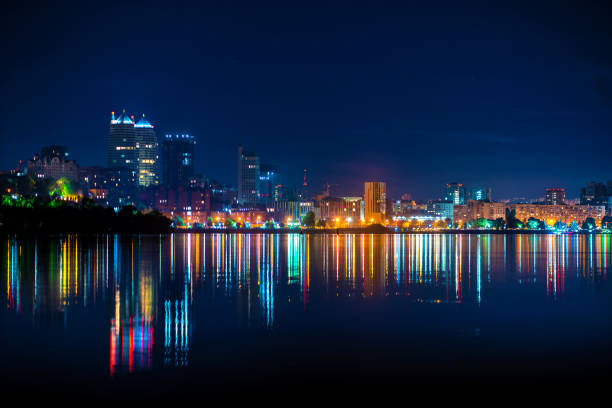 night landscape of the city promenade with many colored lights reflected in the water. night landscape of the city promenade with many colored lights reflected in the water. dnipropetrovsk stock pictures, royalty-free photos & images