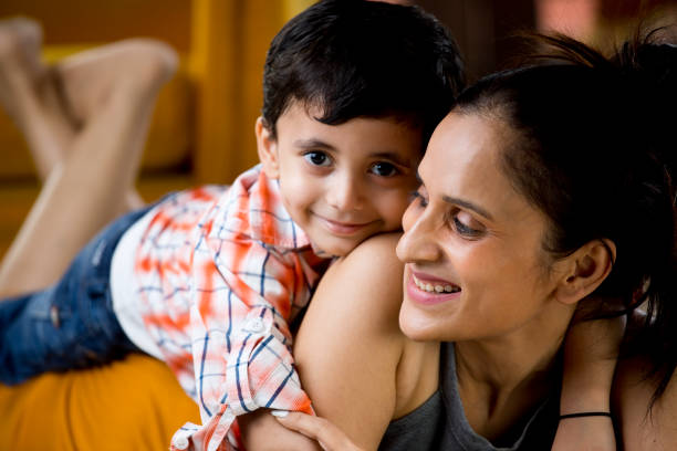 istock Mother with baby son on her back at home 1187637399