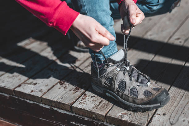 istock Woman hiking tying shoelace 1187638874