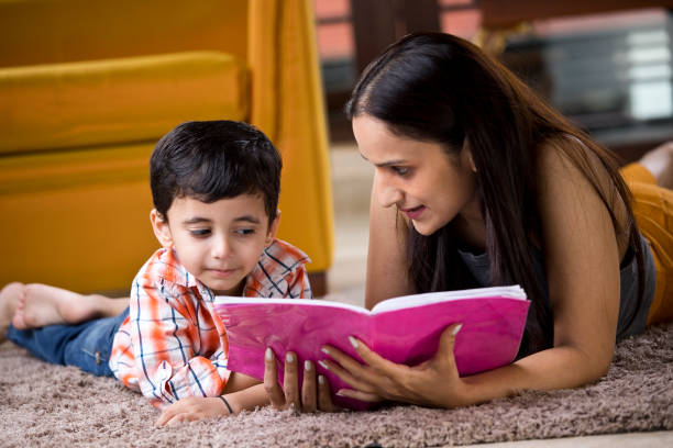 istock Astonished mother with son writing in book 1187639093