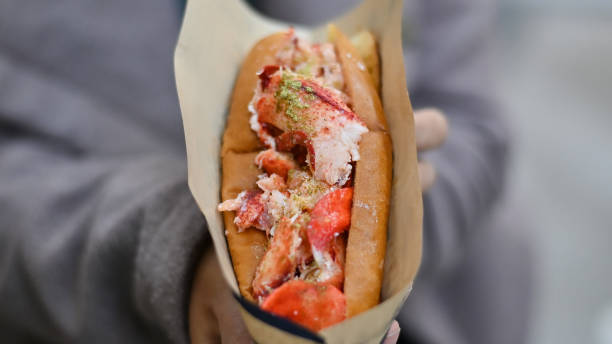 istock Sandwich lobster sliced on female hands. 1187639881