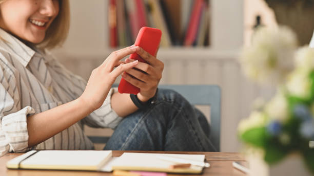 istock Young woman holding her smartphone on table with copy space. 1187639925
