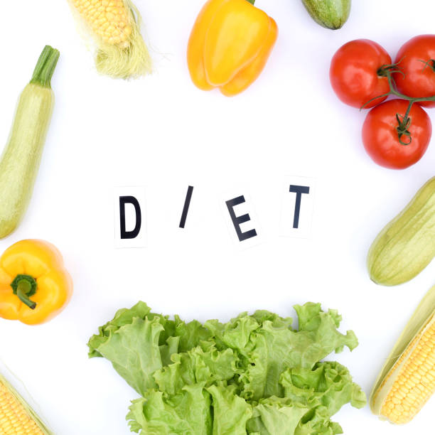 istock Flat lay on an isolated white background with vegetables and the inscription diet. 1187640114