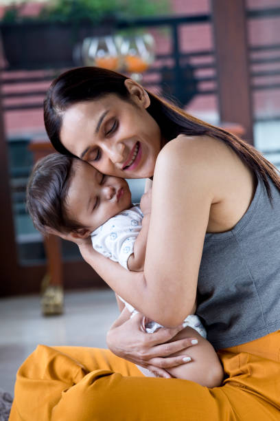 istock Mother holding sleeping baby boy 1187640479
