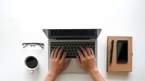istock Man hands working on modern laptop. Office desktop on white table. 1187640510