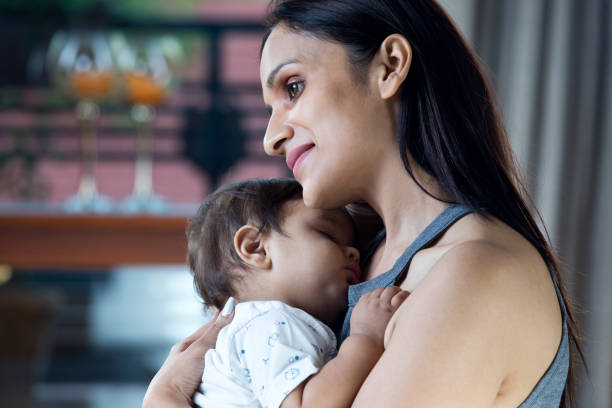 istock Mother holding sleeping baby boy 1187640557