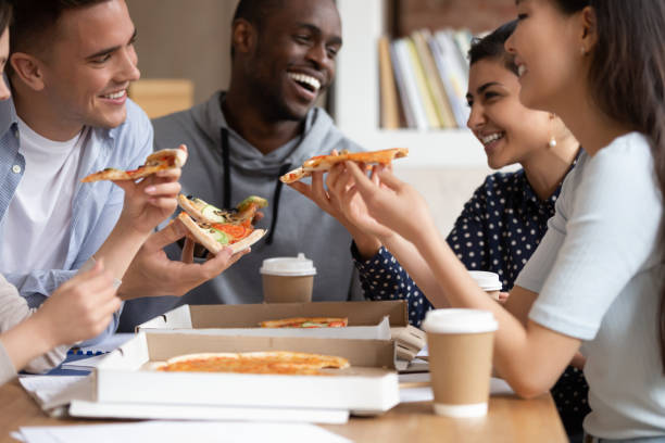 istock Multi national best friends students eating pizza during lunch 1187643058