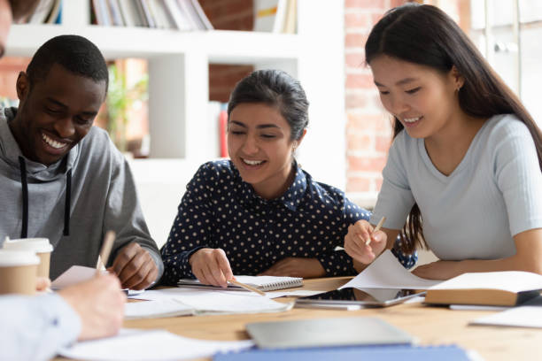 istock Indian, african, asian classmates do school assignment together indoors 1187643076