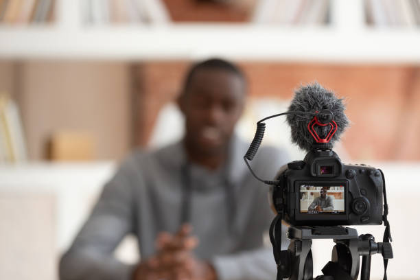Camera view african guy recording educational video for online course Close up professional dslr screen showing african guy sit in front of camera recording job interview self-introduction or film educational video for online high school course share knowledge concept reportage stock pictures, royalty-free photos & images