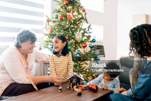 Children Preparing Nativity With Grandmother Stock Photo - Download Image Now - Nativity Scene, Christmas, Family