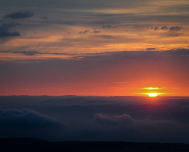 istock The Solar Sphere descends between High Clouds and Low Fogs 1187644738
