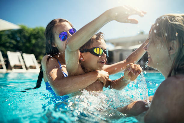 istock Family playing in swimming pool 1187645061