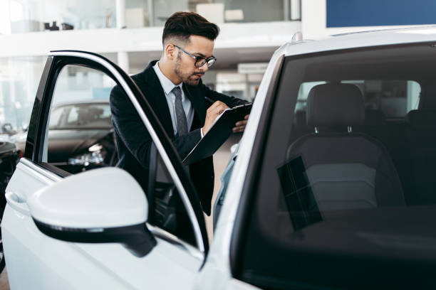istock Car salesman checking new car 1187645826