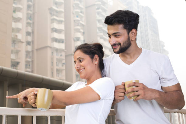 istock Couple drinking coffee and admiring view from balcony 1187646988