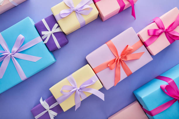istock flat lay with colorful presents with bows on purple background 1187647149