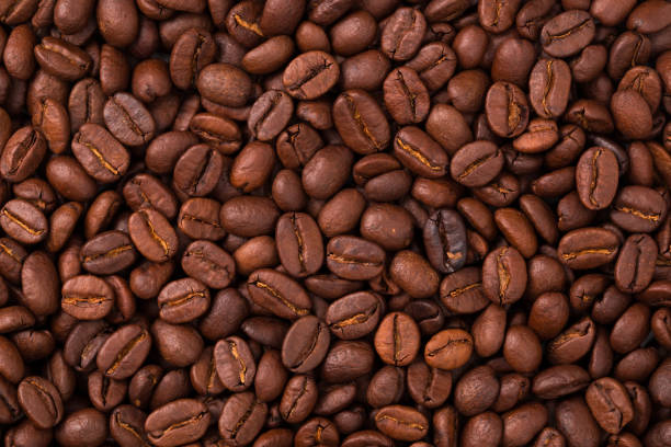 istock fresh Roasted coffee beans closeup. Background textured 1187648835