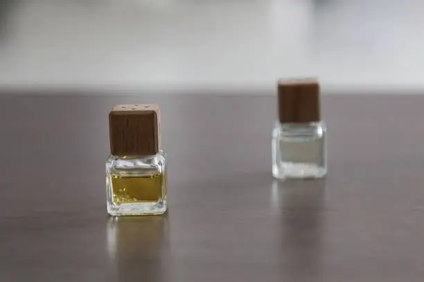 Photo of Two small perfume bottles on the table