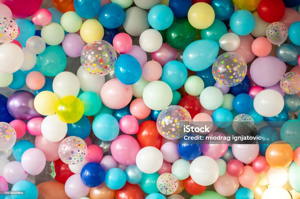 Colorful balloons on wall Wall full of colorful balloons, bunch of balloons hanging Balloon Stock Photo