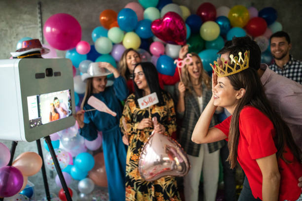 istock Young friends having fun at photo booth party 1187651037