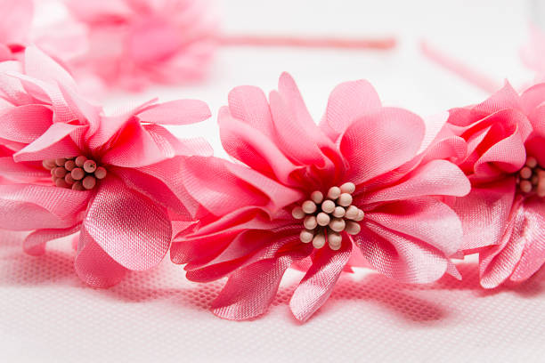 istock Baby hair accessory with pink flowers on white background 1187651823