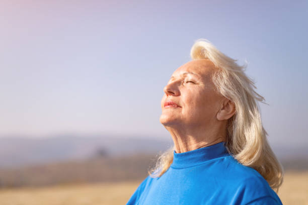 istock Relaxed senior woman meditating in nature. 1187652036