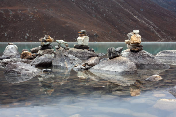 Cairns made in the water, in the sacred lake of gokyo on the three passes trek.