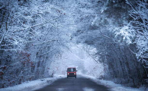 istock Red car on the winter road 1187652479