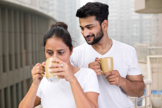 istock Couple drinking coffee and admiring view from balcony 1187653301